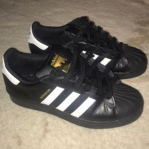 Black adidas with white stripes
